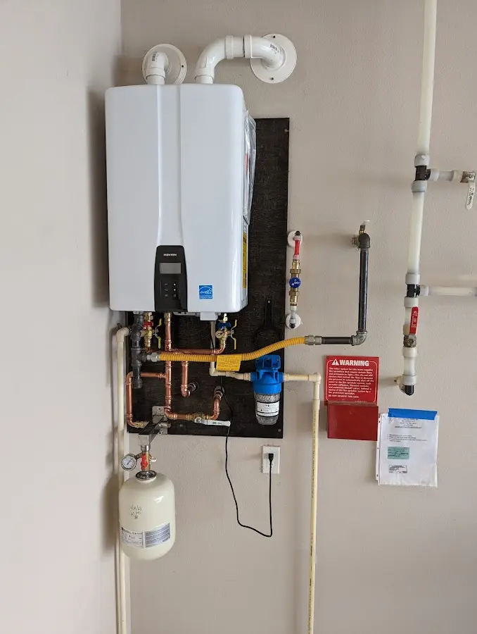 Professional plumber installing copper piping in a Prairie Ridge home